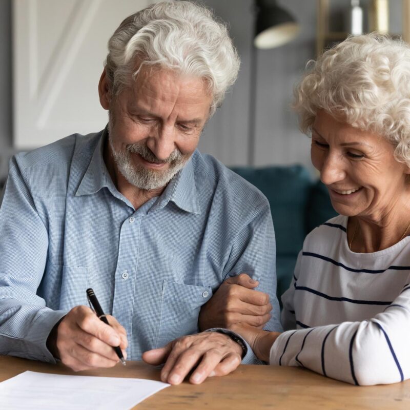 Older couple signing paperwork