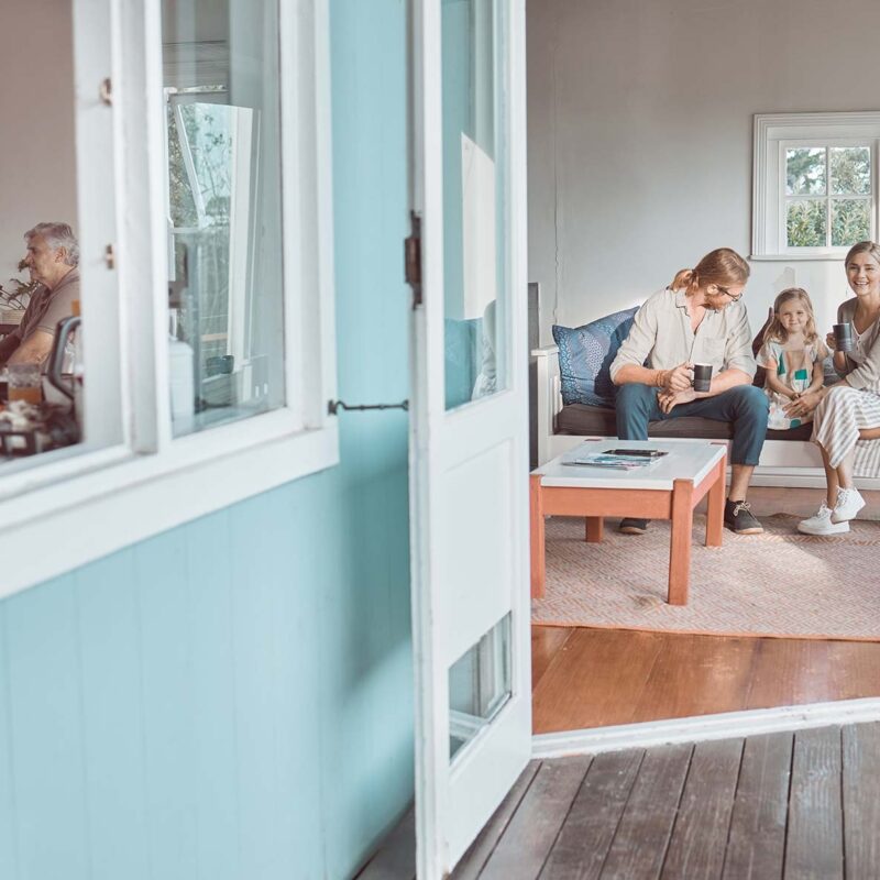 Outside looking through front door at family